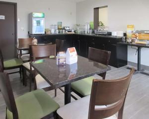 a restaurant with a table and chairs and a counter at Quality Inn Farmington in Farmington