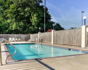 a swimming pool in front of a wooden fence at Econo Lodge Greenville in Greenville +16 photos