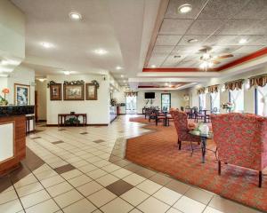 a lobby with a waiting area with chairs and tables at Quality Inn & Suites in Clinton