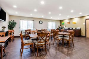 a dining room with wooden tables and chairs at Quality Inn in Batesville