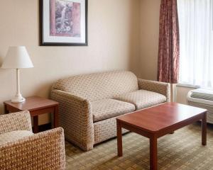 a living room with a couch and a table at Quality Inn Louisville in Louisville