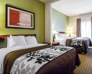 a hotel room with two beds in a room at Sleep Inn & Suites in Hattiesburg