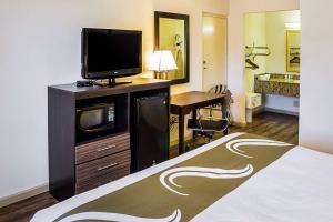a hotel room with a bed and a television at Quality Inn Biloxi Beach in Biloxi