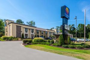 un hotel con un cartello su un palo in un parcheggio di Comfort Inn Tupelo Central a Tupelo