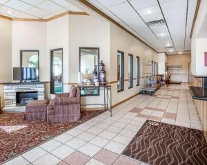a living room with a couch and a fireplace at FairBridge Inn & Suites Glendive in Glendive