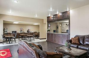 un salon avec des meubles en cuir et un restaurant dans l'établissement Econo Lodge Livingston Gateway to Yellowstone, à Livingston