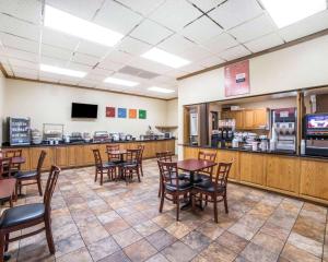 a dining room with tables and chairs in a restaurant at FairBridge Inn & Suites Glendive in Glendive