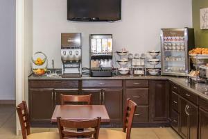 a kitchen with a counter with a table and chairs at Sleep Inn Missoula in Missoula