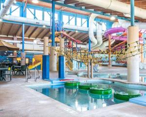 a large indoor swimming pool with a water park at Big Horn Resort, Ascend Hotel Collection in Billings
