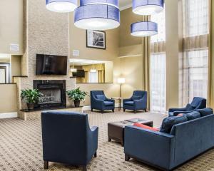 a lobby with couches and chairs and a tv at Comfort Suites Research Park - University in Charlotte