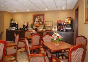 a restaurant with tables and chairs and a counter at Quality Inn & Suites Tarboro - Kingsboro in Tarboro