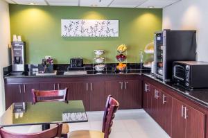 a kitchen with a counter with a table and a microwave at Sleep Inn Matthews in Charlotte
