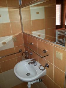 a bathroom with a sink and a mirror at Apartmany Danka in Pavčina Lehota