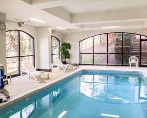 a swimming pool in a house with windows at Comfort Suites Regency Park in Cary