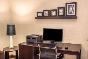 a desk with a computer and a printer and a lamp at Sleep Inn Raleigh Durham Airport in Durham