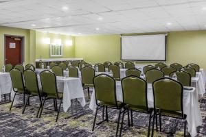 a conference room with tables and chairs and a screen at Quality Suites Pineville - Charlotte in Charlotte +25 photos