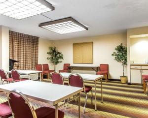 a conference room with tables and chairs and a podium at Quality Inn University in Winston-Salem
