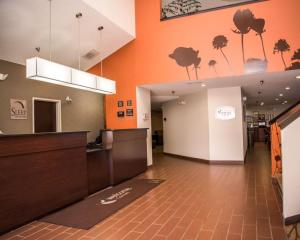 an empty lobby of a office with orange walls at Sleep Inn & Suites at Concord Mills in Concord