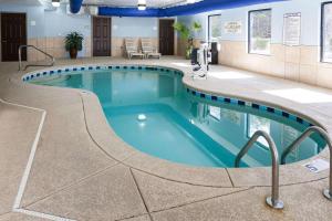a pool in a hotel room with blue water at Comfort Inn & Suites Statesville - Mooresville in Statesville