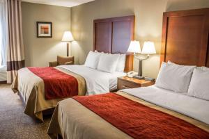 a hotel room with two beds and a telephone at Comfort Inn Research Triangle Park in Durham