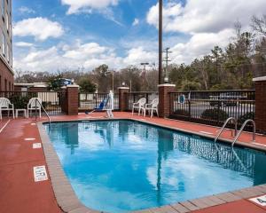 a large swimming pool with chairs and a slide at Comfort Inn & Suites in Lumberton