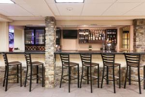 a bar in a restaurant with black stools at Comfort Inn & Suites Statesville - Mooresville in Statesville