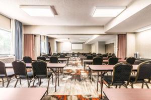 an empty room with tables and chairs and a classroom at Lake Norman Inn and Suites in Cornelius