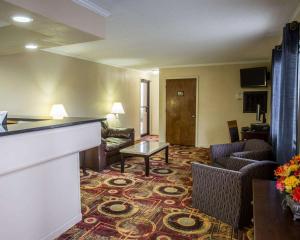 a living room with a couch and a table at Rodeway Inn & Suites Plymouth Hwy 64 in Plymouth