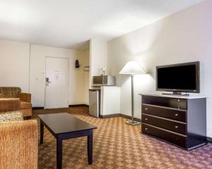 a living room with a flat screen tv and a couch at Quality Inn & Suites Coliseum in Greensboro