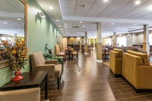 a lobby with chairs and tables and a waiting room at Sleep Inn & Suites Mount Olive North in Mount Olive
