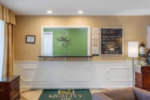 a lobby with a waiting area with a monkey sign on the wall at Quality Inn Laurinburg in Laurinburg