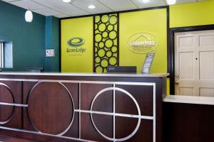 a reception desk in a dental office with yellow walls at Econo Lodge in Selma