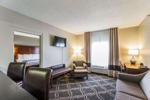 a hotel room with a bed and a large window at Comfort Suites Pineville - Ballantyne Area in Charlotte
