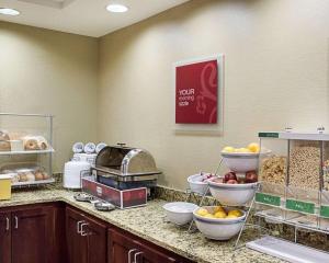 a kitchen filled with lots of different types of food at Comfort Suites Minot in Minot