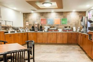 a fast food restaurant with wooden cabinets and tables at Comfort Inn Dickinson in Dickinson