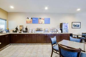 a fast food restaurant with a counter and chairs at Comfort Inn & Suites Bellevue - Omaha Offutt AFB in Bellevue