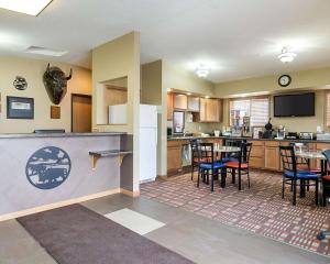 a kitchen and dining room with a table and chairs at Econo Lodge Jamestown in Jamestown