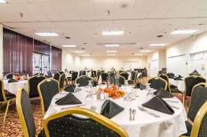 a banquet room with tables and chairs with white tablecloths at Quality Inn & Suites in Ogallala