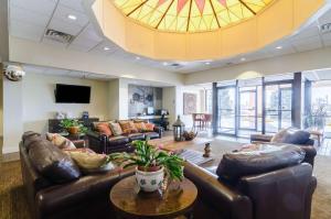 a large living room with leather furniture and a large ceiling at Quality Inn & Suites in Ogallala