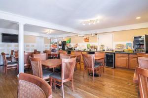 a restaurant with wooden tables and chairs and a counter at Quality Inn North Conway in North Conway