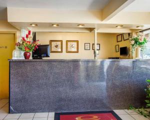 a bar in a hotel lobby with flowers on the counter at Econo Lodge in Somers Point
