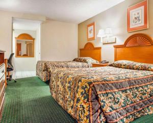 a hotel room with two beds and a television at Rodeway Inn Mount Laurel Hwy 73 in Mount Laurel