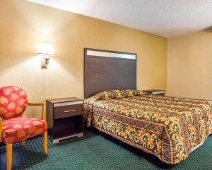 a hotel room with a bed and a chair at Rodeway Inn Mount Laurel Hwy 73 in Mount Laurel