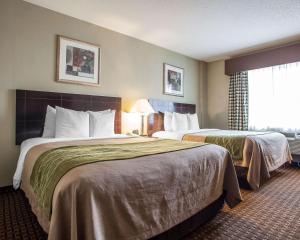 a hotel room with two beds and a window at Avon Hotel - Toms River in Toms River