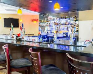 a bar with two chairs in front of it at Clarion Hotel Somerset - New Brunswick in Somerset