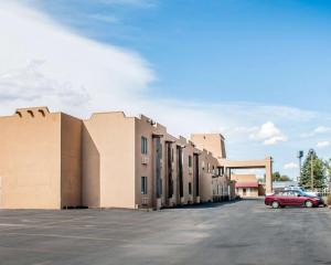 a building with a car parked in a parking lot at Rodeway Inn in Espanola