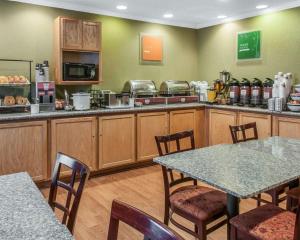 a kitchen with a table and chairs in a restaurant at Quality Inn & Suites Farmington in Farmington
