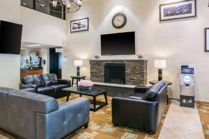 a living room with leather furniture and a fireplace at Quality Inn Edison-New Brunswick in Edison