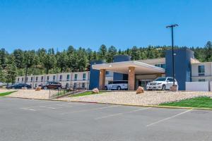 a large building with cars parked in a parking lot at Elevate Hotel at Sierra Blanca Ruidoso, Ascend Hotel Collection in Ruidoso