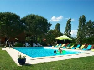 a woman is playing in a swimming pool at Les Chalets des Mousquetaires in Mirepoix